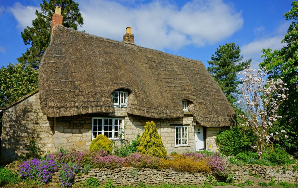 The architectural variety of Cotswolds property, Thatched Cottage in Spring